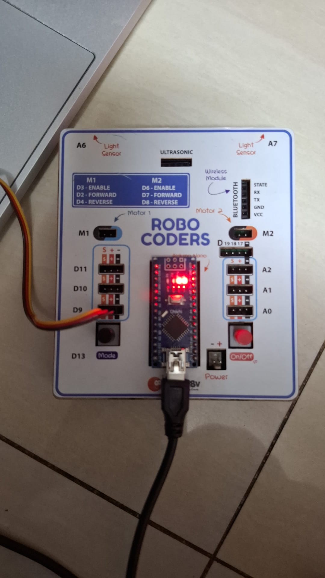 The Be Cre8v board — the tiny brain running the show, servo wired to D9.