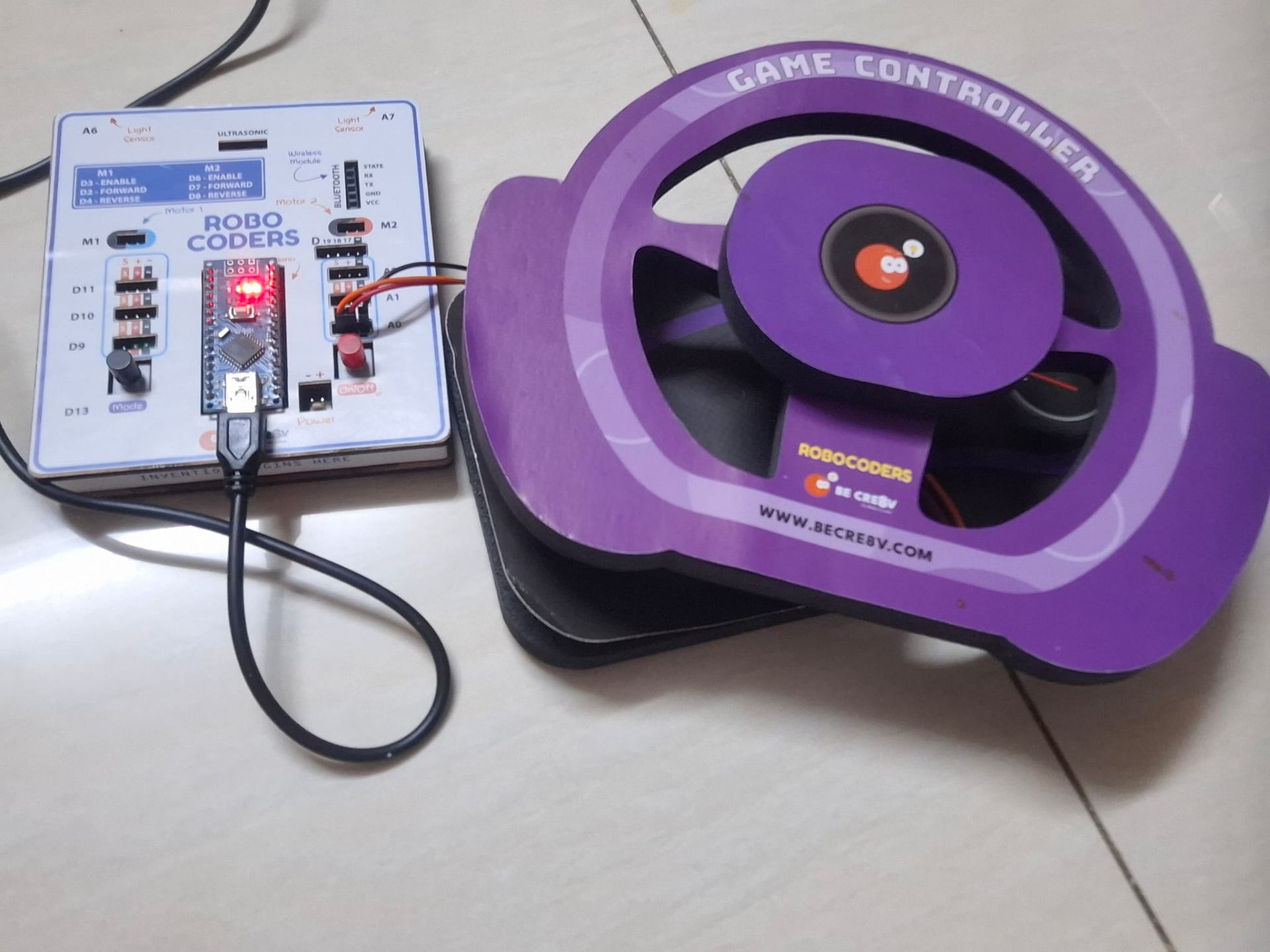 The Be Cre8v RoboCoders board wired to the purple game controller wheel.