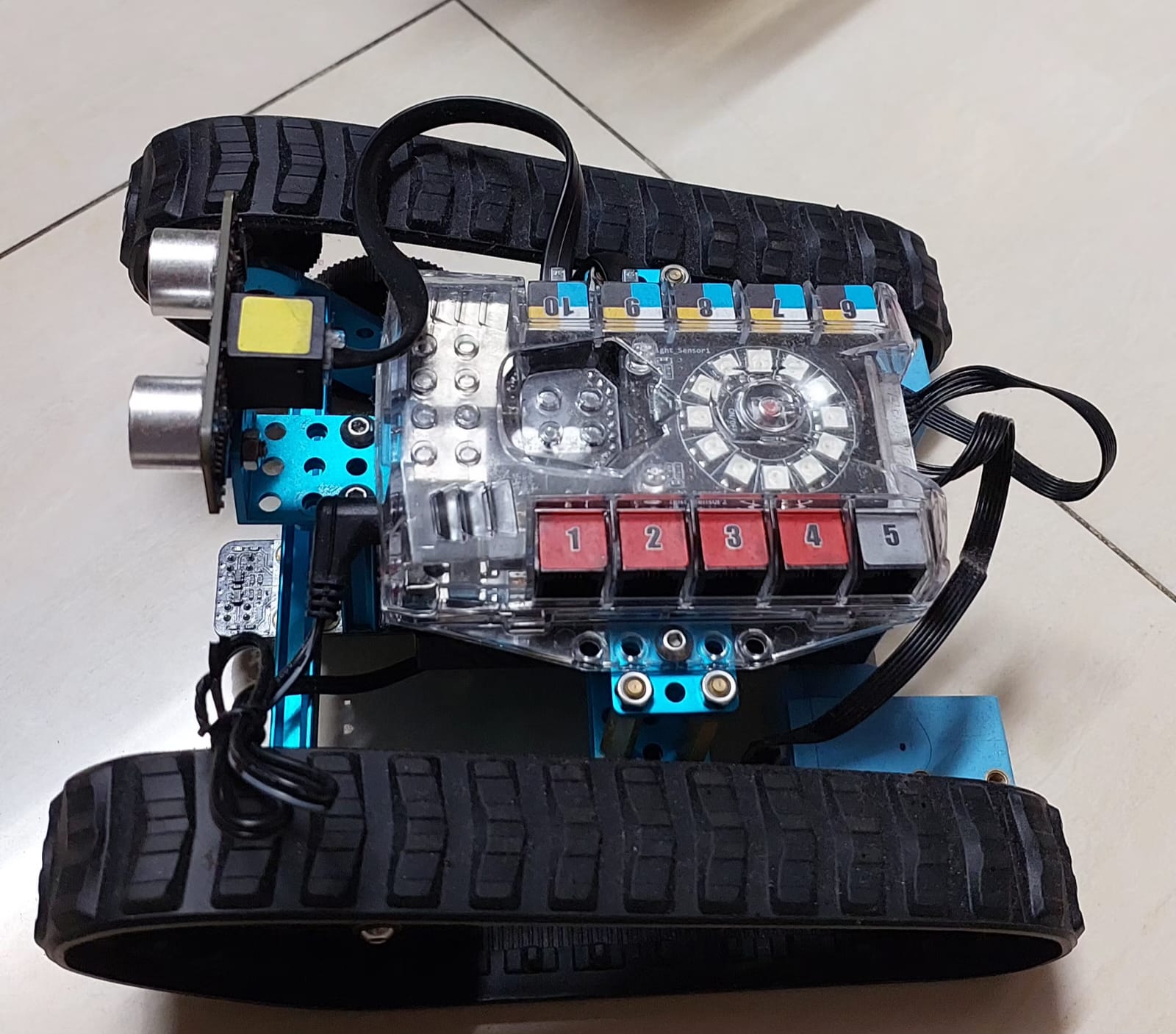 Top view — the mCore control board, LED ring, and button matrix wired to the tank chassis.